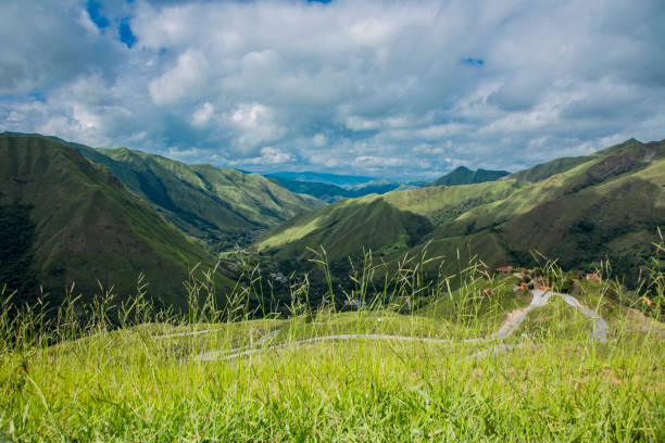 Venezuela - Aragua State green mountains - valley landscape seen fron a hill. Beautiful cloudy sky in a sunny spring day. High angle view. Wilderness area. Mountain range.