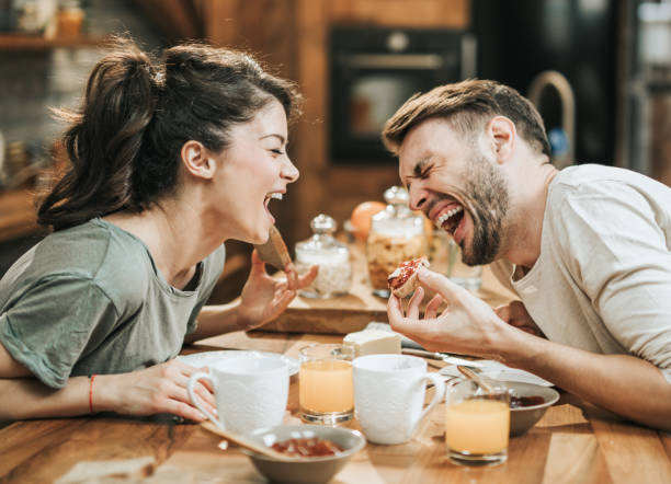 istock Cheerful couple laughing during breakfast at home. 1135486188