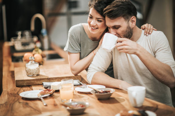 istock Embraced couple in love enjoying during coffee time in the kitchen. 1135486766