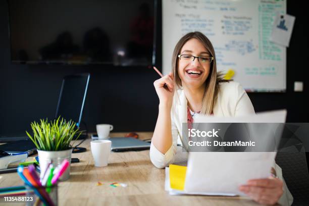 Portrait Of Confident Business Woman Writing Document Sitting At Workplace In Office Copy Space Stock Photo - Download Image Now