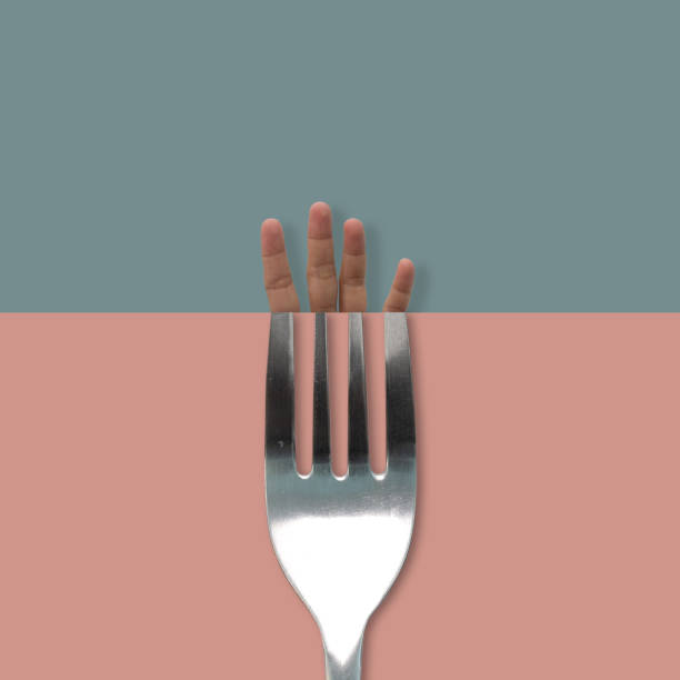 istock Contemporary art-hand and fork on blue, pink background. 1135488740