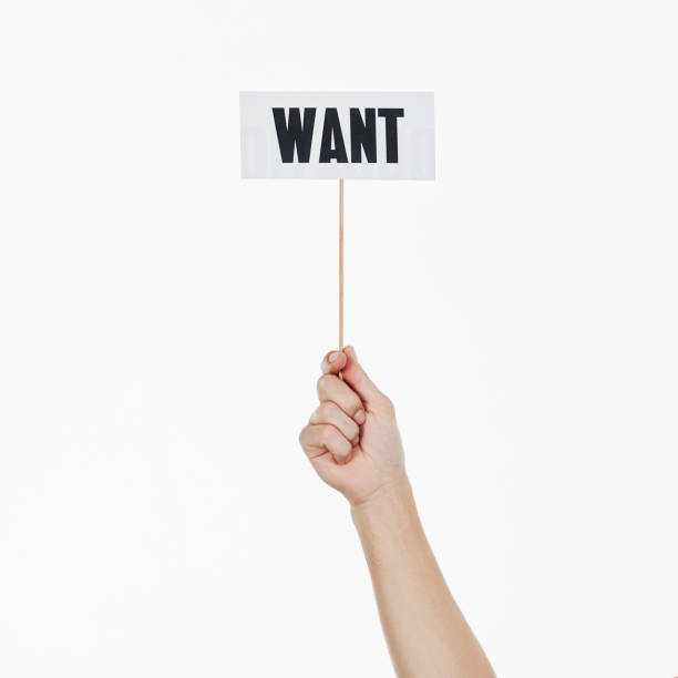 istock Single raised hand holds sign reading 