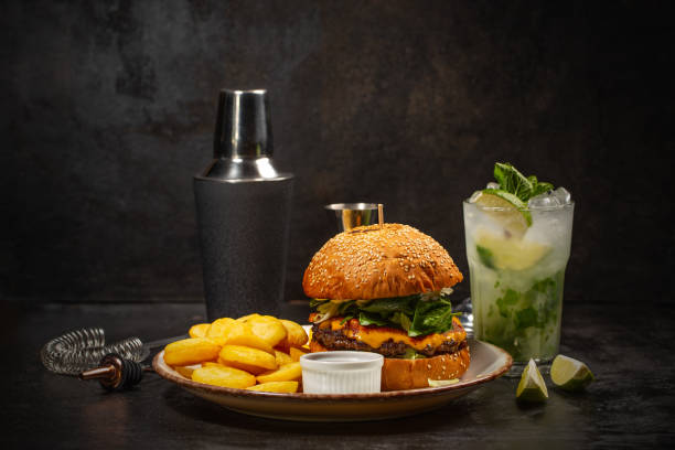 Burger and glass of mojito stock photo