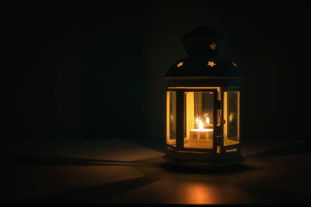 istock Golden lighthouse with a burning candle inside at night 1135490612