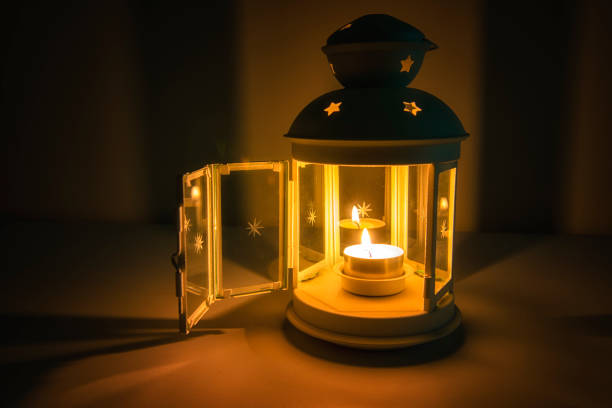 istock Golden lighthouse with a burning candle inside at night 1135490640