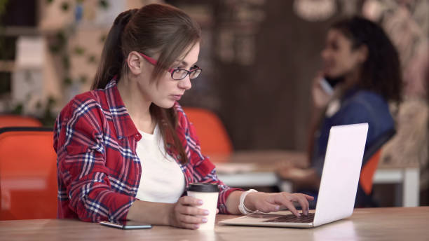 istock Intellectual woman typing on laptop in cafe, freelancer working on new project 1135490694