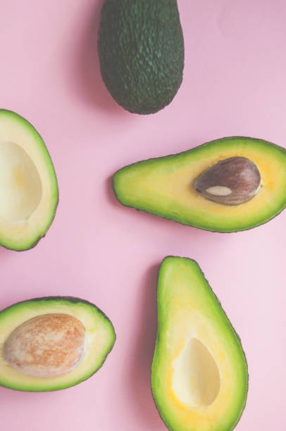 istock Halved avocados on pink background. 1135490723