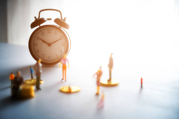 istock Miniature people: Business man standing on coins 1135490766