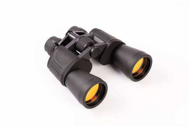 istock Black binoculars with orange lens isolated on white background 1135492275