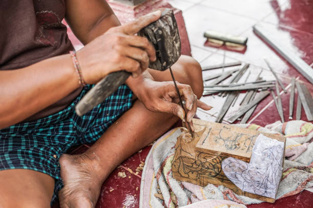 istock a man is carving wood 1135492433