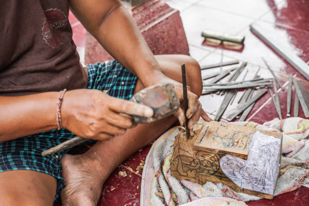 istock a man is carving wood 1135492505