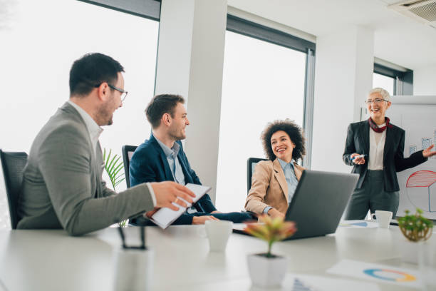 istock Smiling old business woman at presentation 1135492538