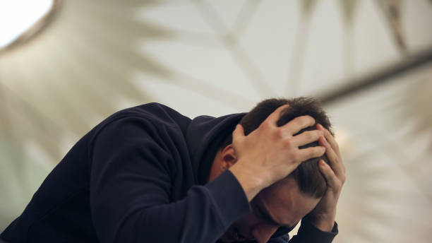 istock Young male holding head, suffering from hangover after night party, vomiting 1135496548
