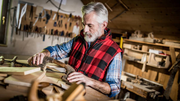 istock Senior carpenter restoring a wooden handle 1135498293