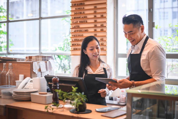 istock Baristas communicating at checkout counter 1135498550