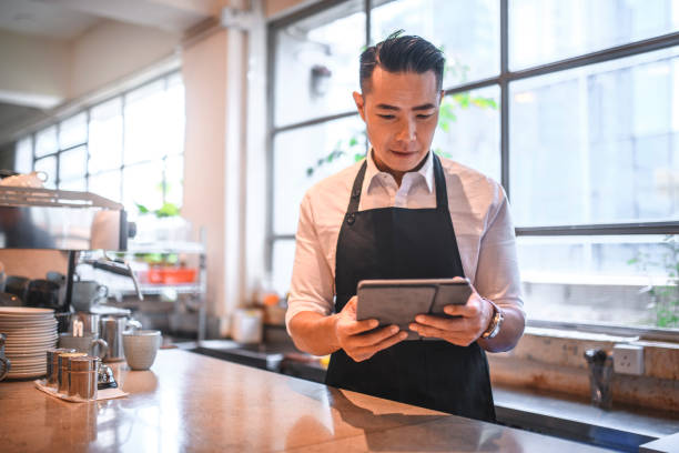 istock Mature barista using digital tablet at counter 1135498552