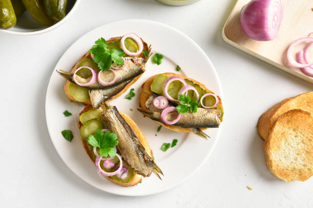 istock Open sandwiches with sprats, marinated cucumber and onion 1135499030