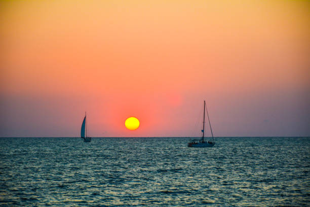 istock Yachts on the walk under the bright rays of the setting sun 1135499179