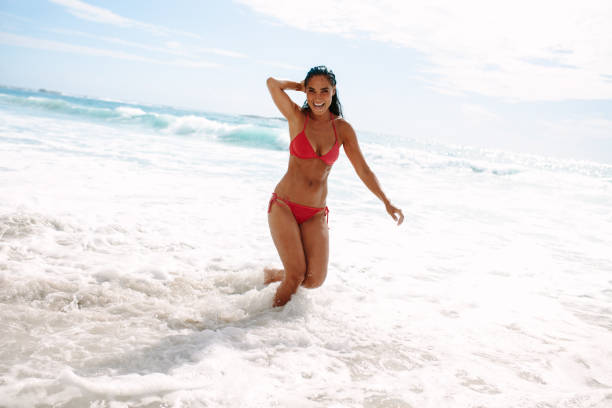 istock Woman enjoying her summer vacation on beach 1135499253