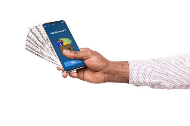 istock Man holding phone with digital wallet app and dollar cash 1135500344
