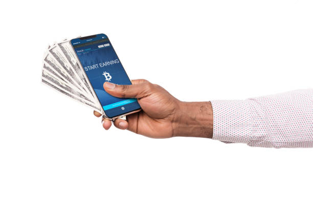 istock Bitcoin earning application on smartphone screen and money 1135500348