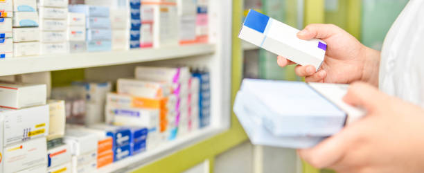 istock Pharmacist holding medicine box in pharmacy 1135502341