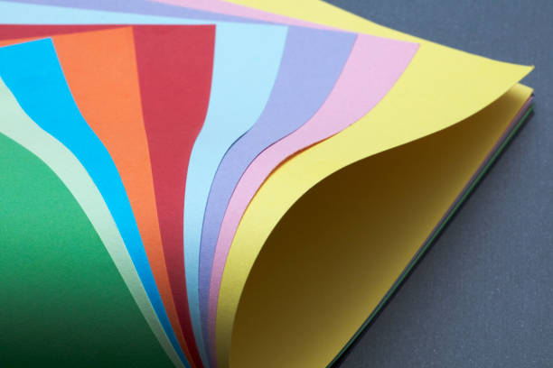 istock Abstract colored papers on blue, pink and orange background. 1135504274