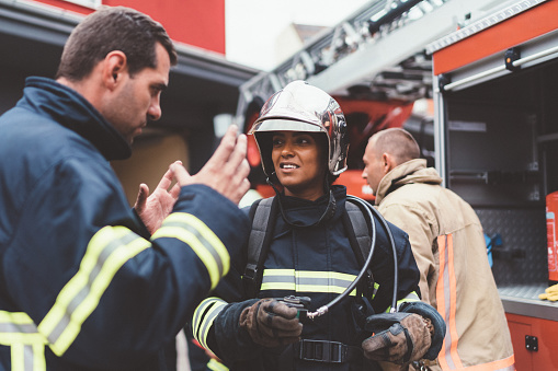 Firefighter man giving instructions to colleague before rescue operation