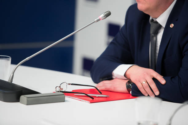 istock Microphone for interviewing and asking questions in news report, with blurred background of journalist 1135504908
