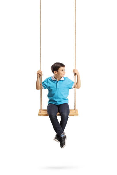 istock Boy sitting on a swing and looking away 1135505029