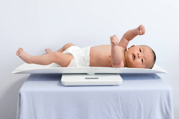 istock Chinese newborn measuring body weight 1135506083
