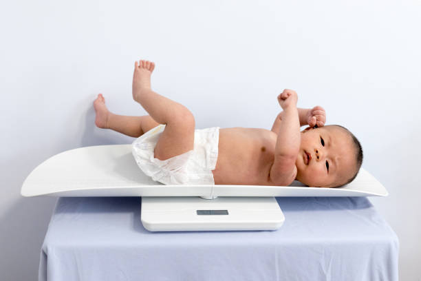 istock Chinese newborn measuring body weight 1135506090
