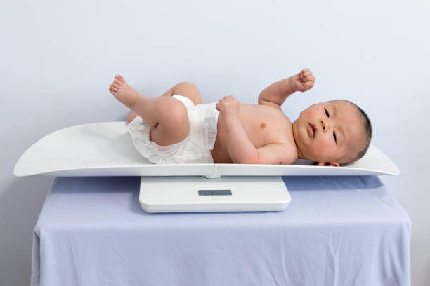 istock Chinese newborn measuring body weight 1135506121