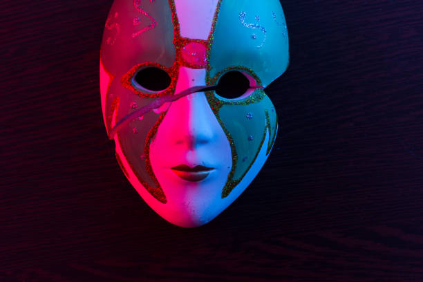 istock White mask on the dark wall 1135508586