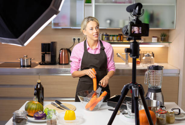 istock Woman making cooking vlog, recording herself on camera 1135508743