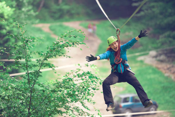 At Tad Fane Waterfall, there is a ZipLine playing for adventure tourist who want to play. Above 220 meters from ground will extremely amaze your experience and it's so fun! located a few kilometres west of Paksong Town, Champasak Province, Southern Laos. Selective focus at Safety Hook of Zip Line.