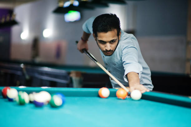 istock Stylish arabian man wear on jeans playing pool billiard on bar. 1135510524