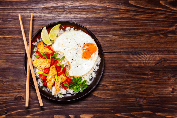 istock Grilled meat, white rice and vegetables on wooden table 1135512822