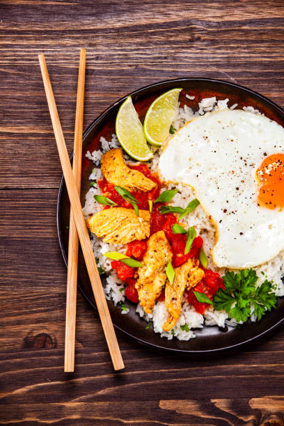 istock Grilled meat, white rice and vegetables on wooden table 1135513107