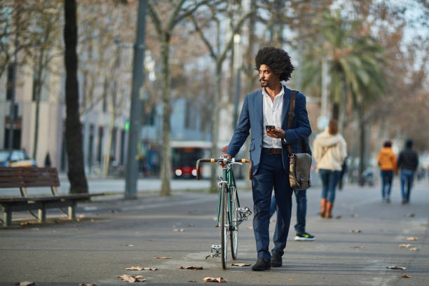 istock Businessman walking with bicycle on street 1135514117
