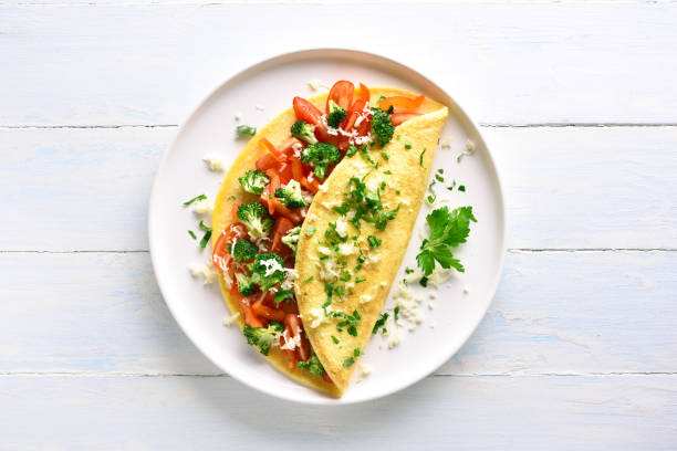 istock Stuffed omelette with tomatoes, red bell pepper and broccoli 1135514124