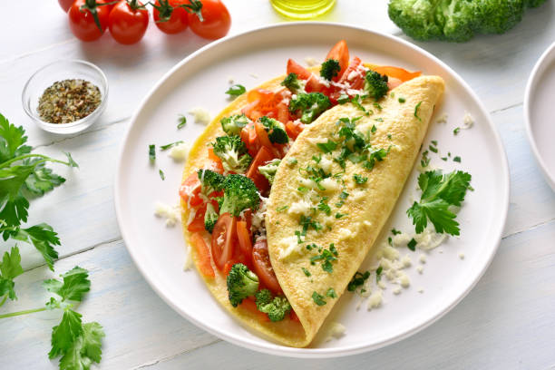 istock Stuffed omelette with tomatoes, red bell pepper and broccoli 1135514125
