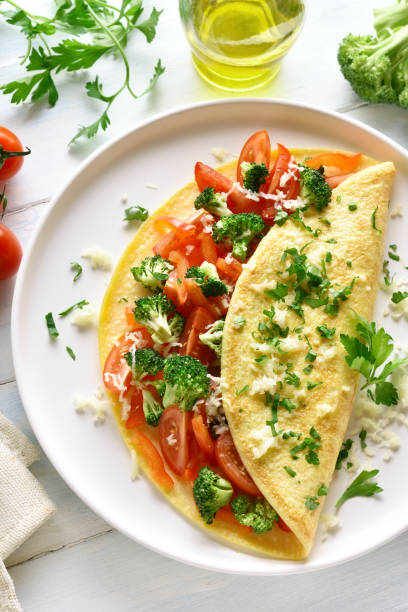 istock Stuffed omelette with tomatoes, red bell pepper and broccoli 1135514126