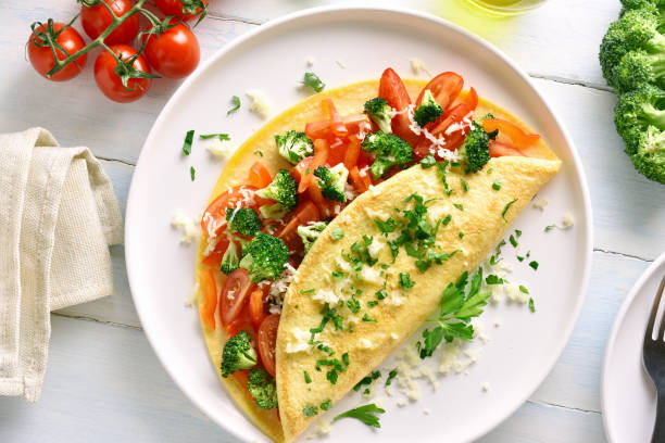 istock Stuffed omelette with tomatoes, red bell pepper and broccoli 1135514127