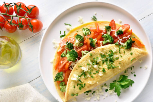 istock Stuffed omelette with tomatoes, red bell pepper and broccoli 1135514133