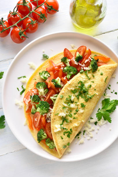 istock Stuffed omelette with tomatoes, red bell pepper and broccoli 1135514137