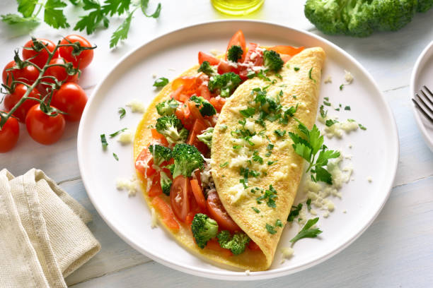 istock Stuffed omelette with tomatoes, red bell pepper and broccoli 1135514138