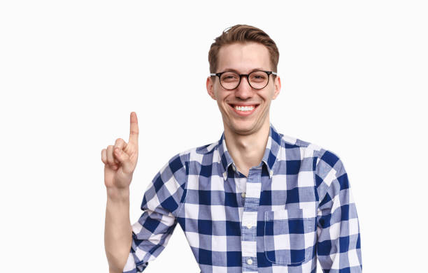 istock Cheerful guy in glasses pointing up 1135514317