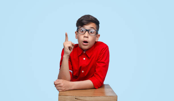 istock Astonished schoolboy pointing up 1135514353