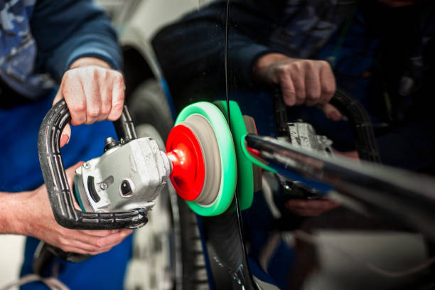 istock Technician polishing a car segment using an electric orbital polisher 1135516678